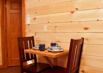 table and chair in one bedroom hot tub cabins